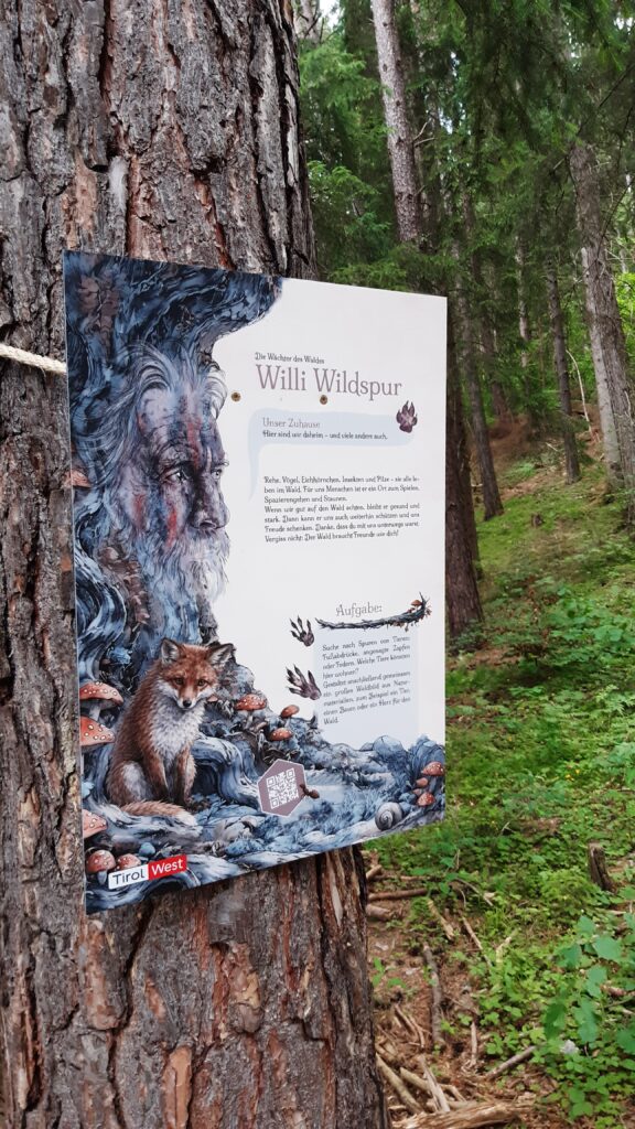 Tafel des Schutzwaldweges mit Portrait eines Baumgeistes von Alrun Lunger.